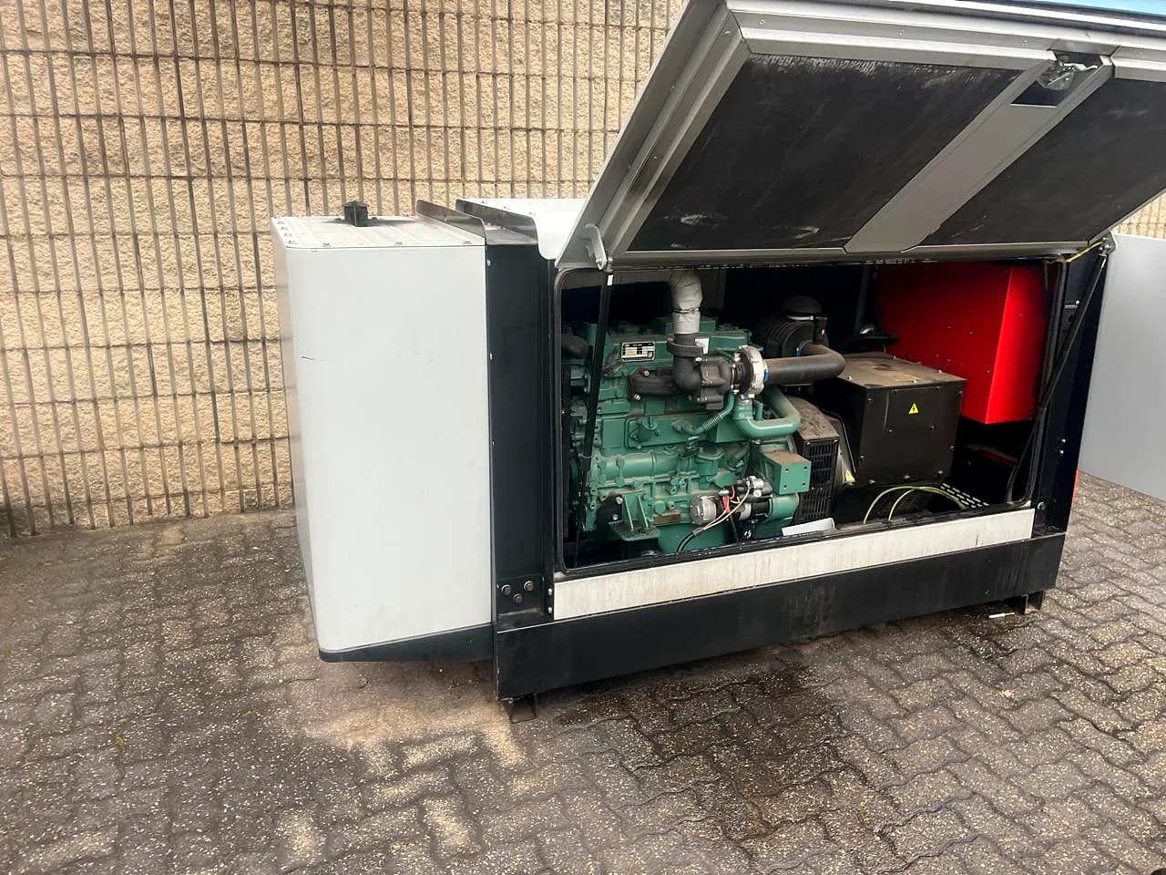 Turbocharged diesel engine inside a generator canopy with the lid raised