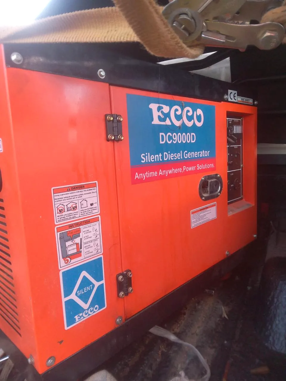 Orange Ecco DC9000D silent diesel generator strapped down with a ratchet strap